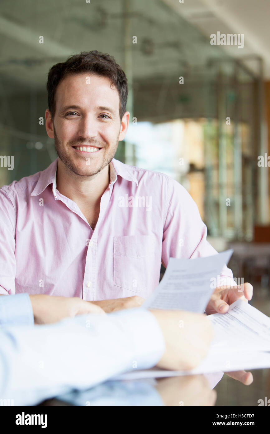 Man reviewing documents with financial advisor Stock Photo