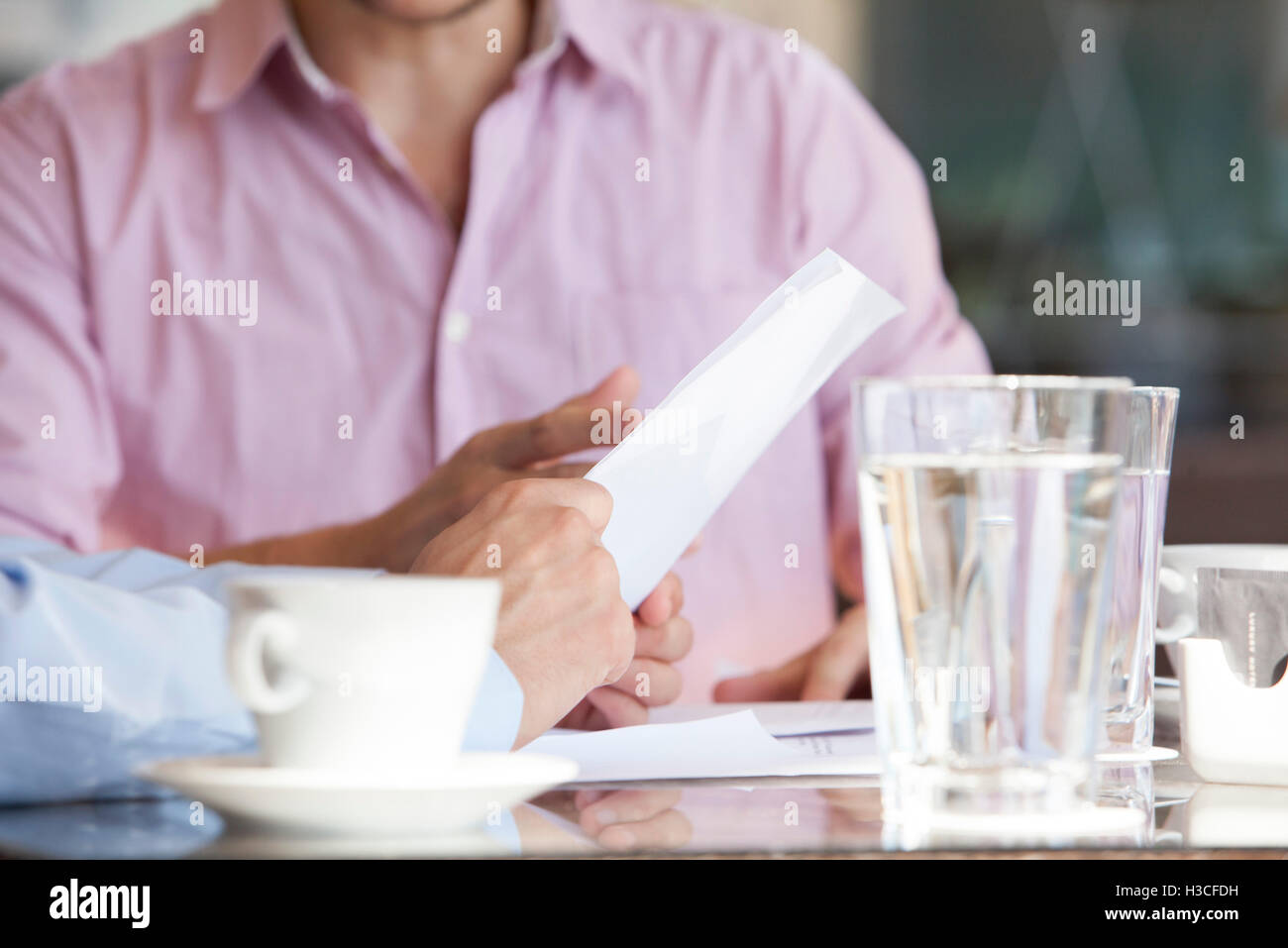 Businessmen discussing business document Stock Photo