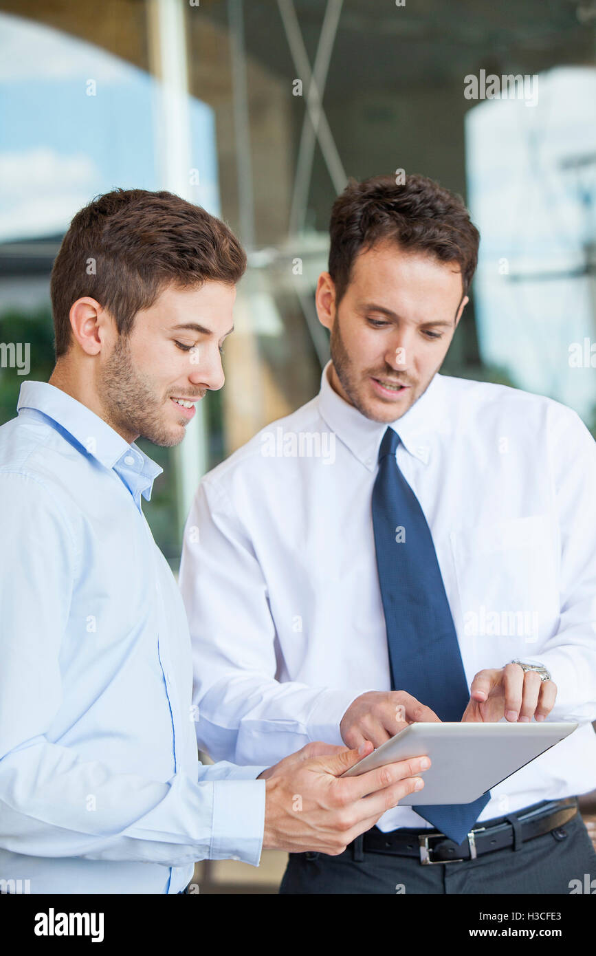 Businessmen collaborating using digital tablet Stock Photo