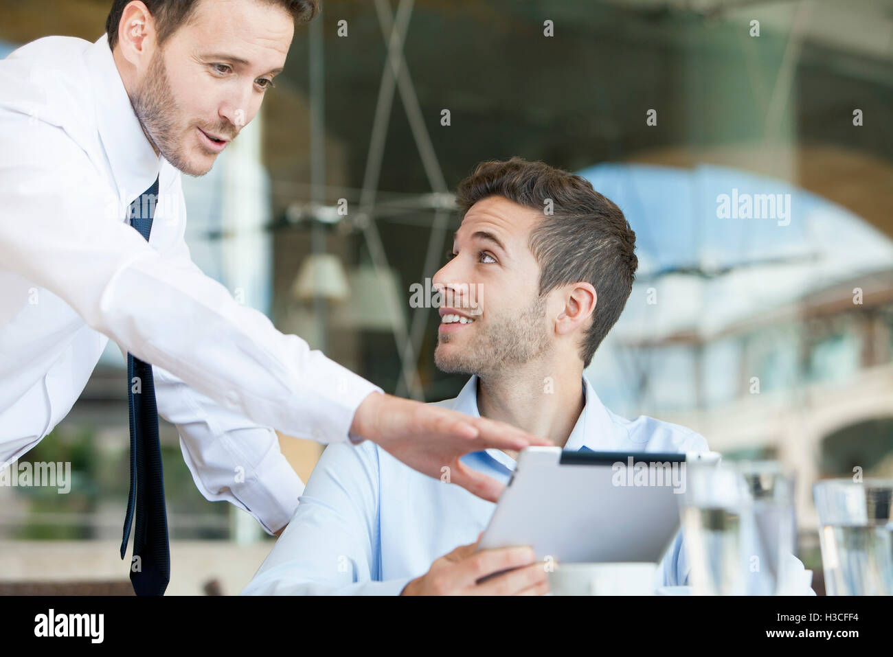 Businessmen collaborating project using digital tablet Stock Photo