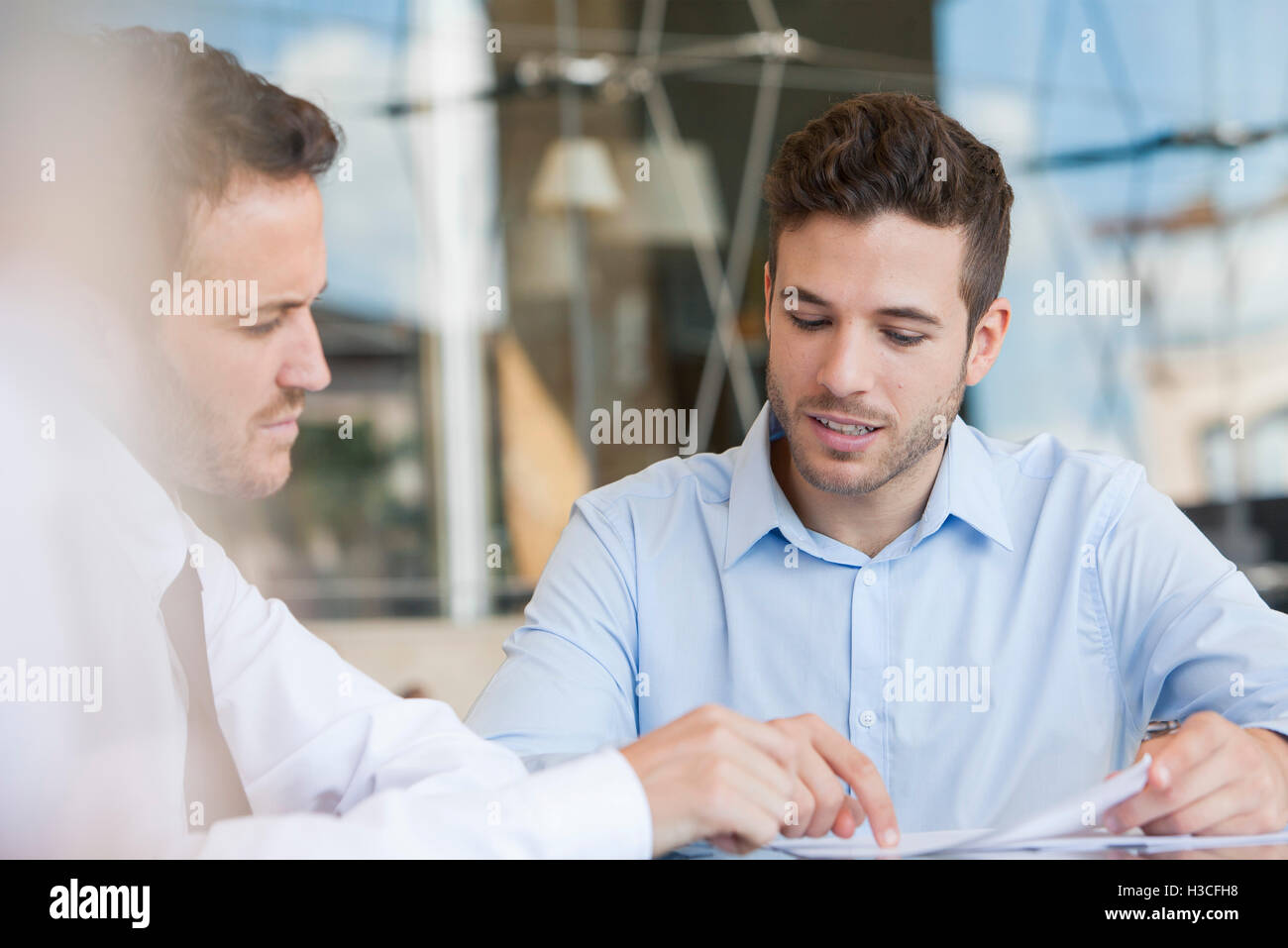 Insurance agent explaining contact to client Stock Photo