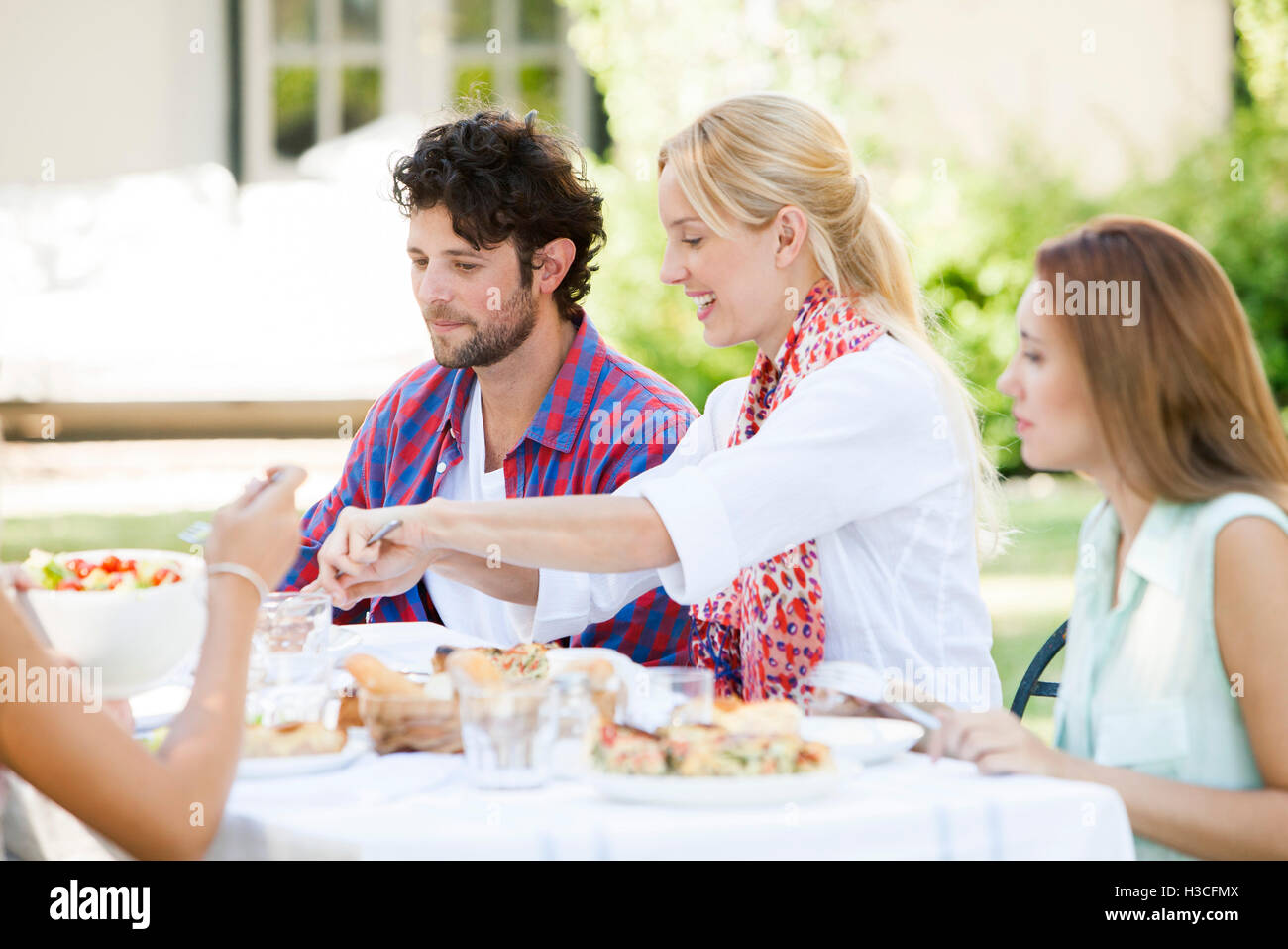 Friends having meal together outdoors Stock Photo
