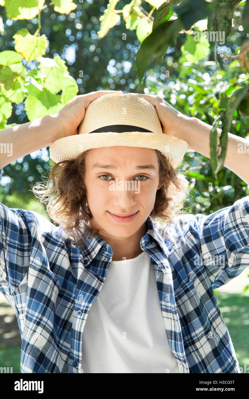 Young man wearing sun hat, portrait Stock Photo