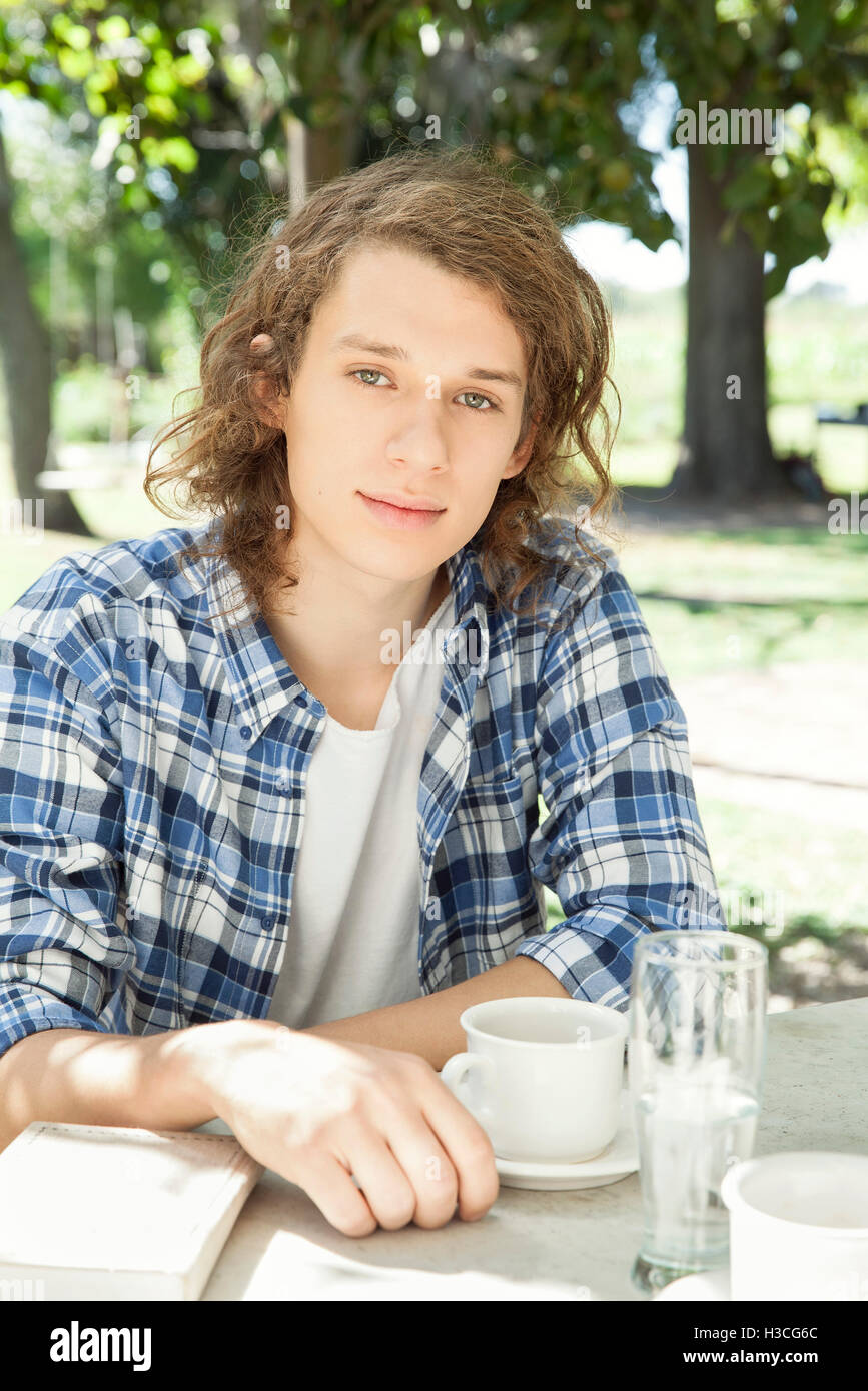 Young man enjoying cup of coffee outdoors Stock Photo