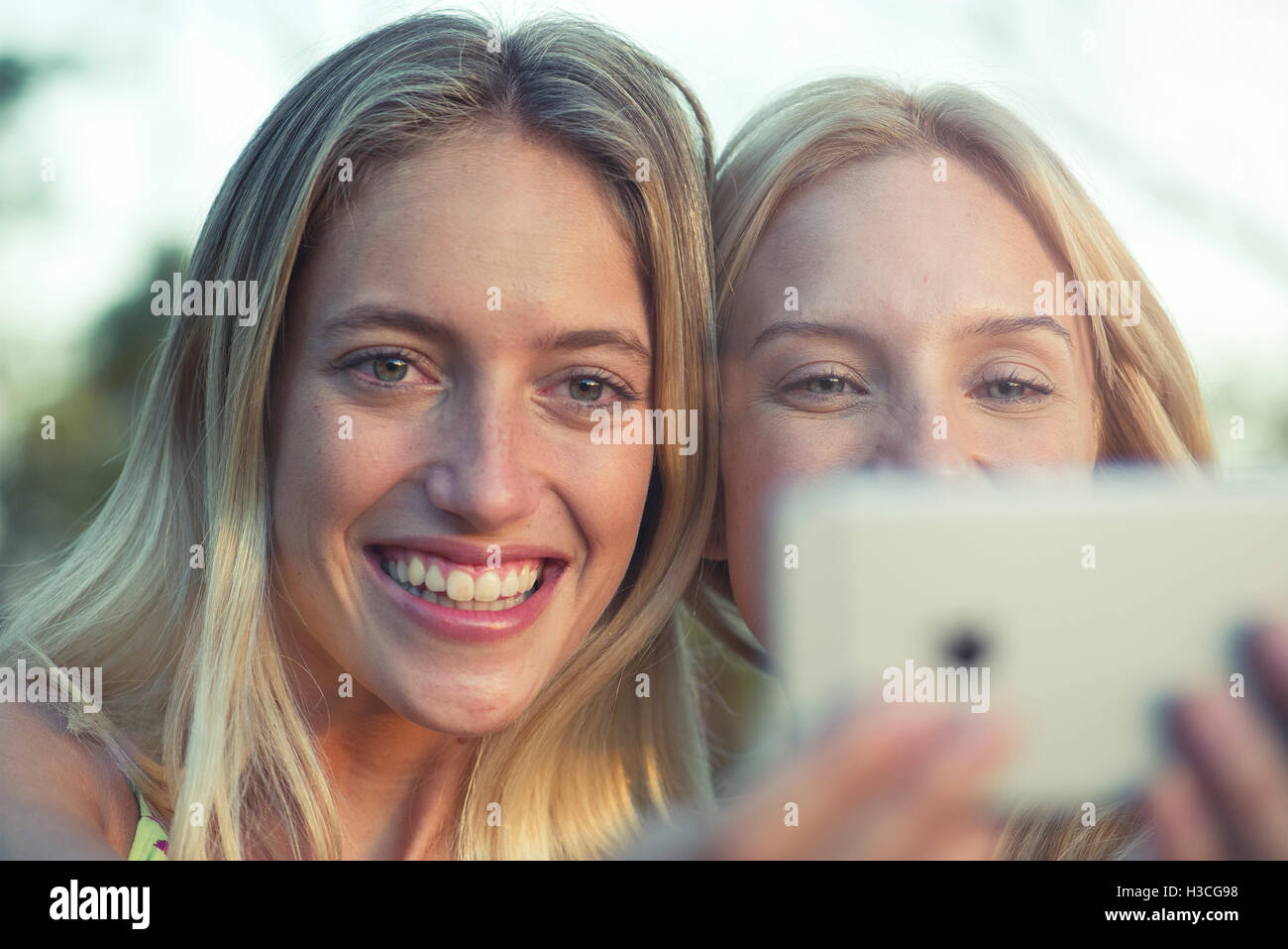 Friends posing for smartphone selfie Stock Photo