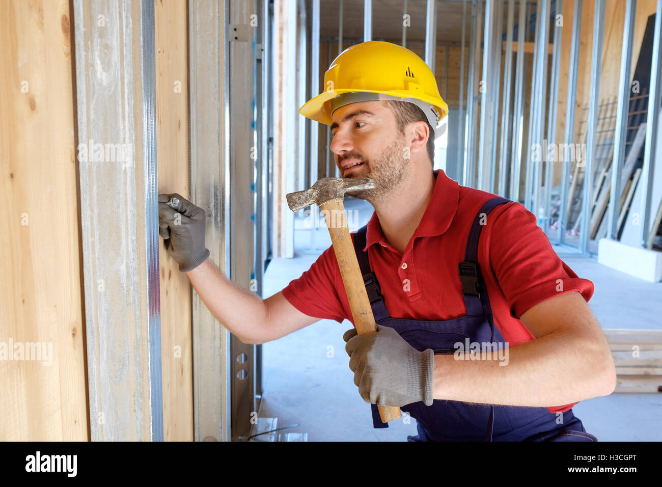 Carpenter using hammer in a construction site Stock Photo Alamy