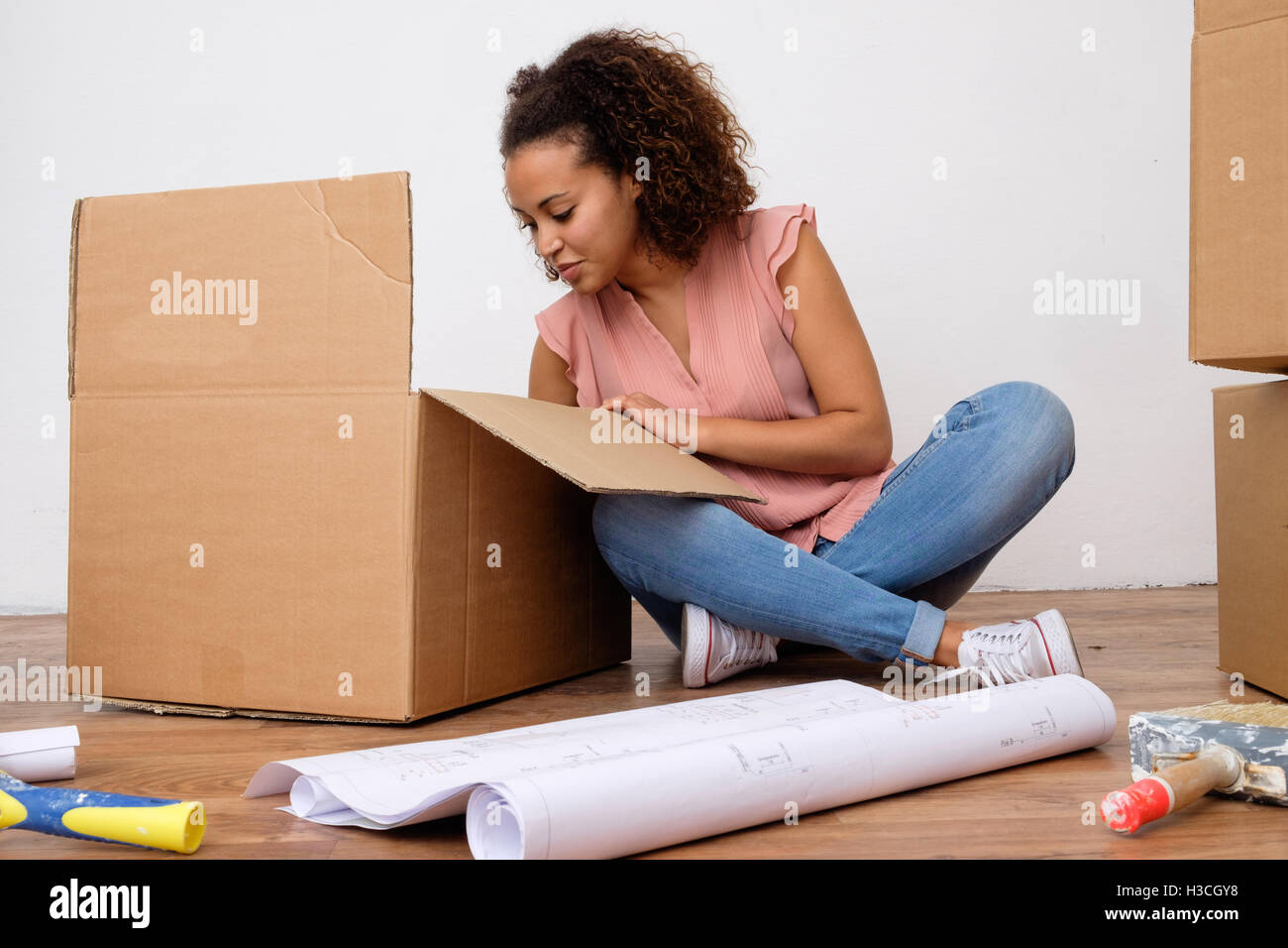 Woman ready for home relocation and renovation Stock Photo