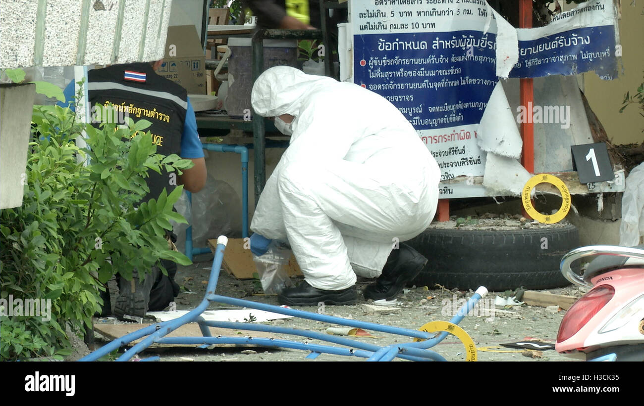 Thai police crime scene investigators search near the clock tower at the site of the second