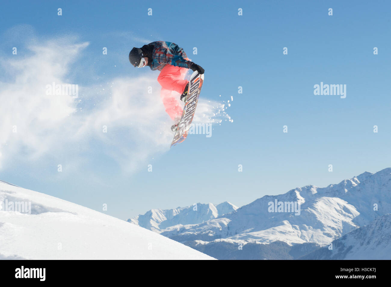 Jump with a snowboard with a grab Stock Photo