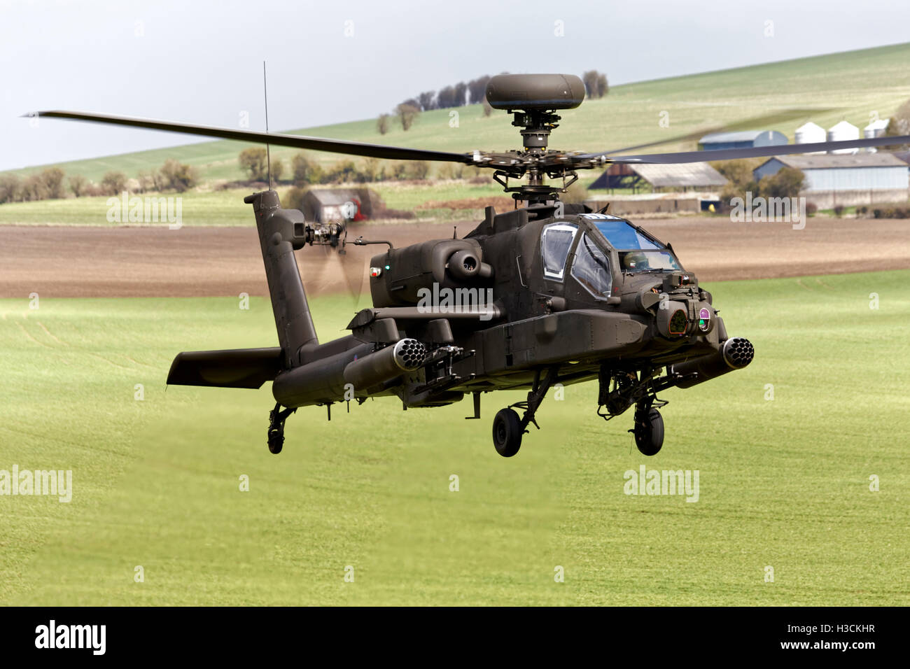 A British Army Air Corps AgustaWestland Apache AH1 Helicopter flying over the Salisbury Plain Training Area in Wiltshire, UK. Stock Photo