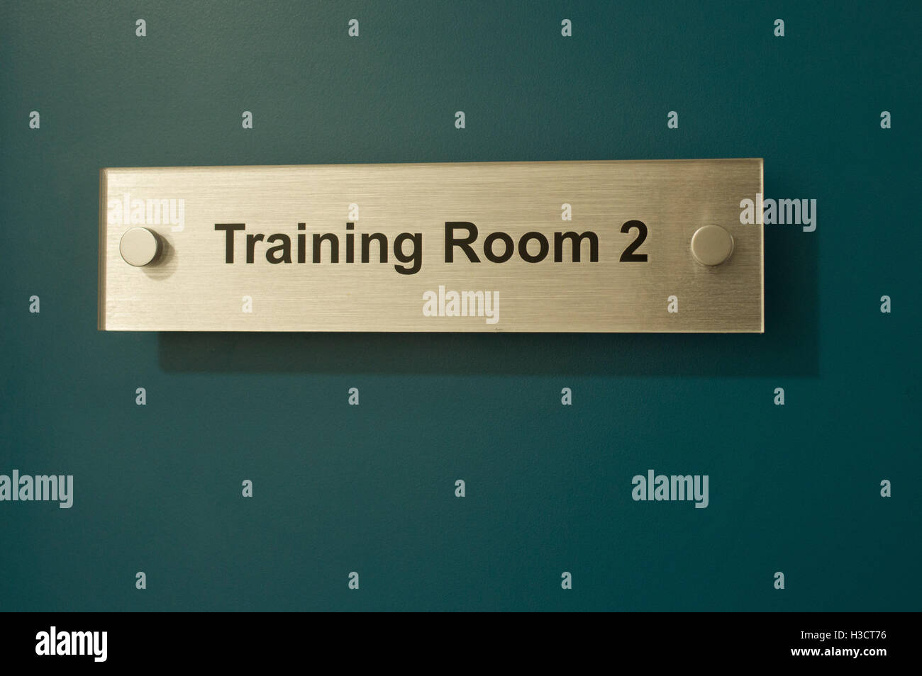 Gold, training room sign on a green door or wall Stock Photo