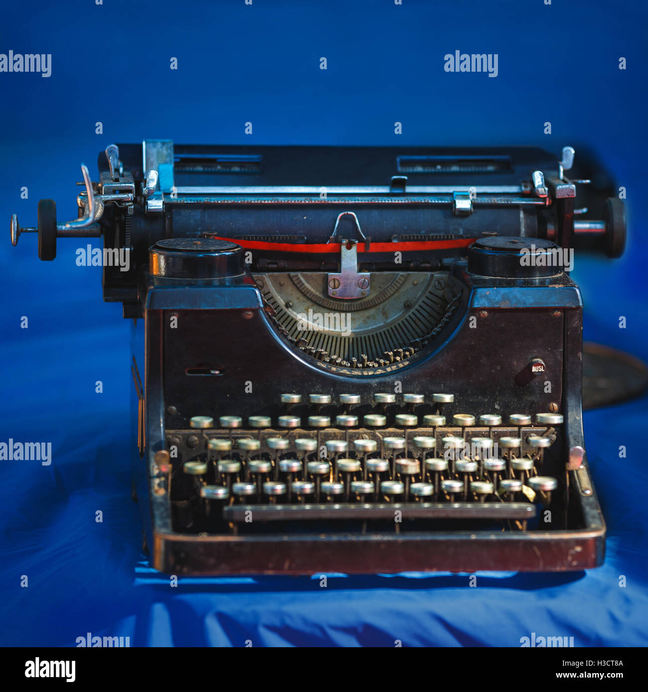 Vintage typewriter on the blue background, close up Stock Photo - Alamy