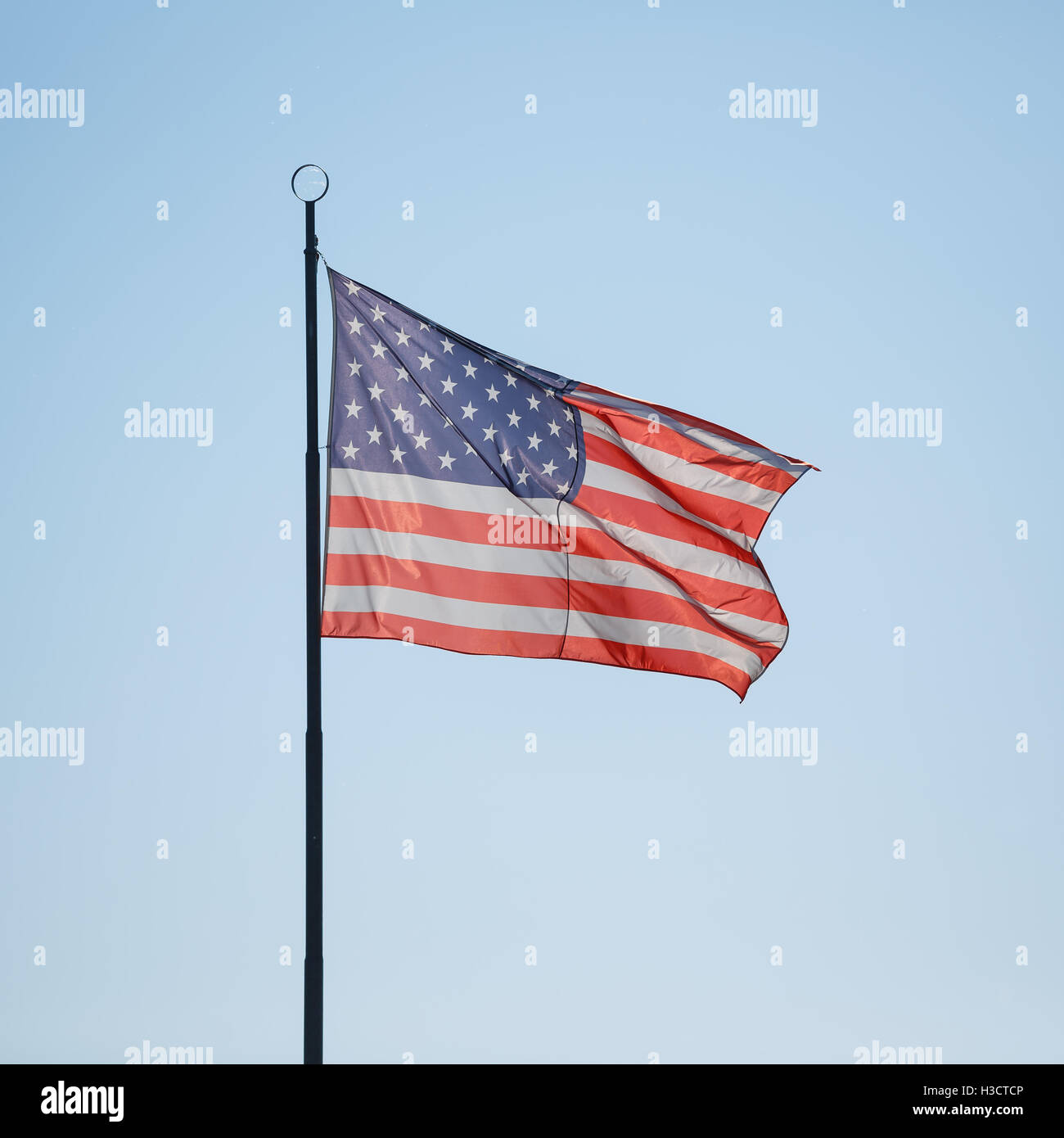 Flag of USA on the blue sky background Stock Photo