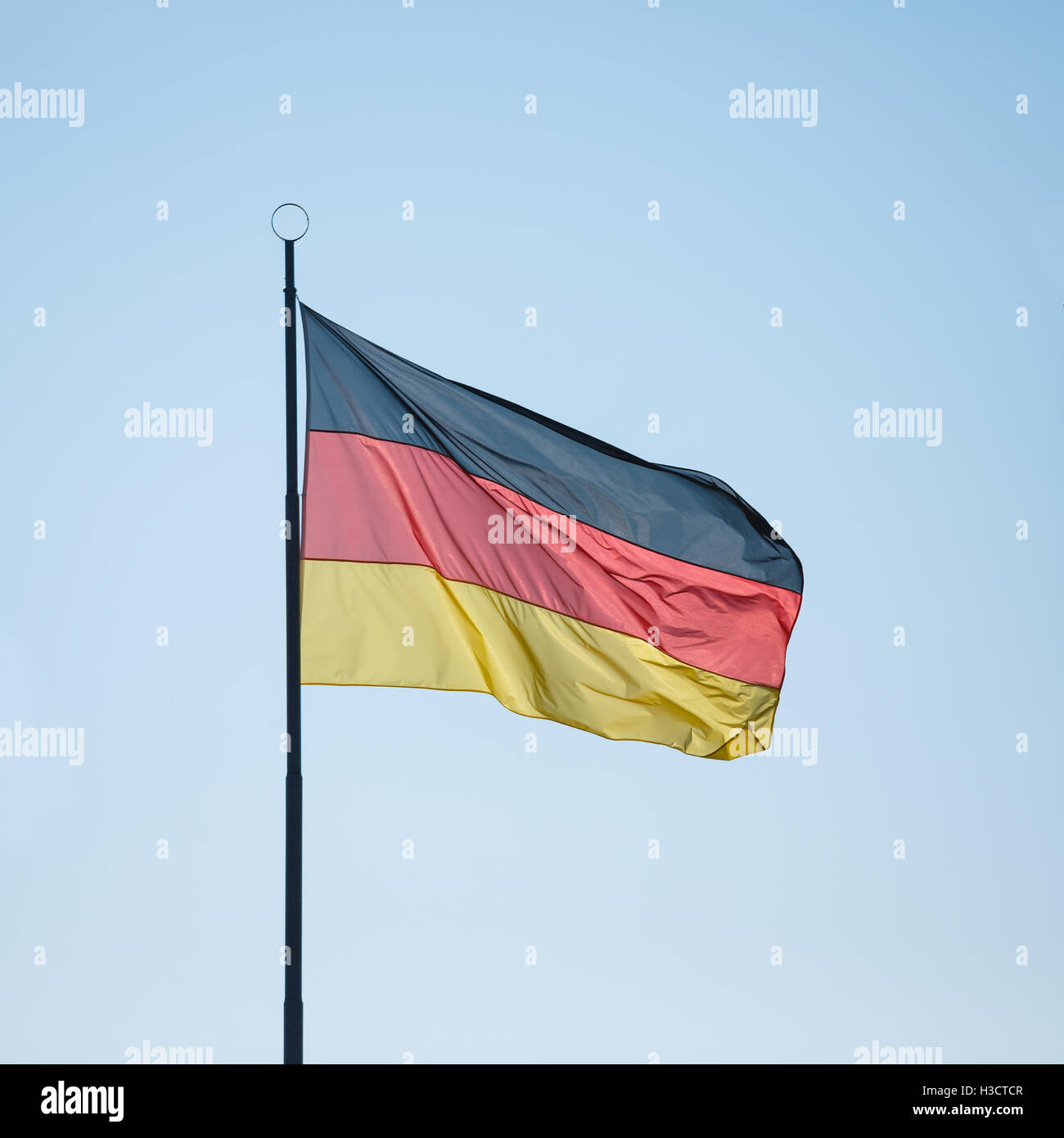 Flag of Germany on the blue sky background Stock Photo