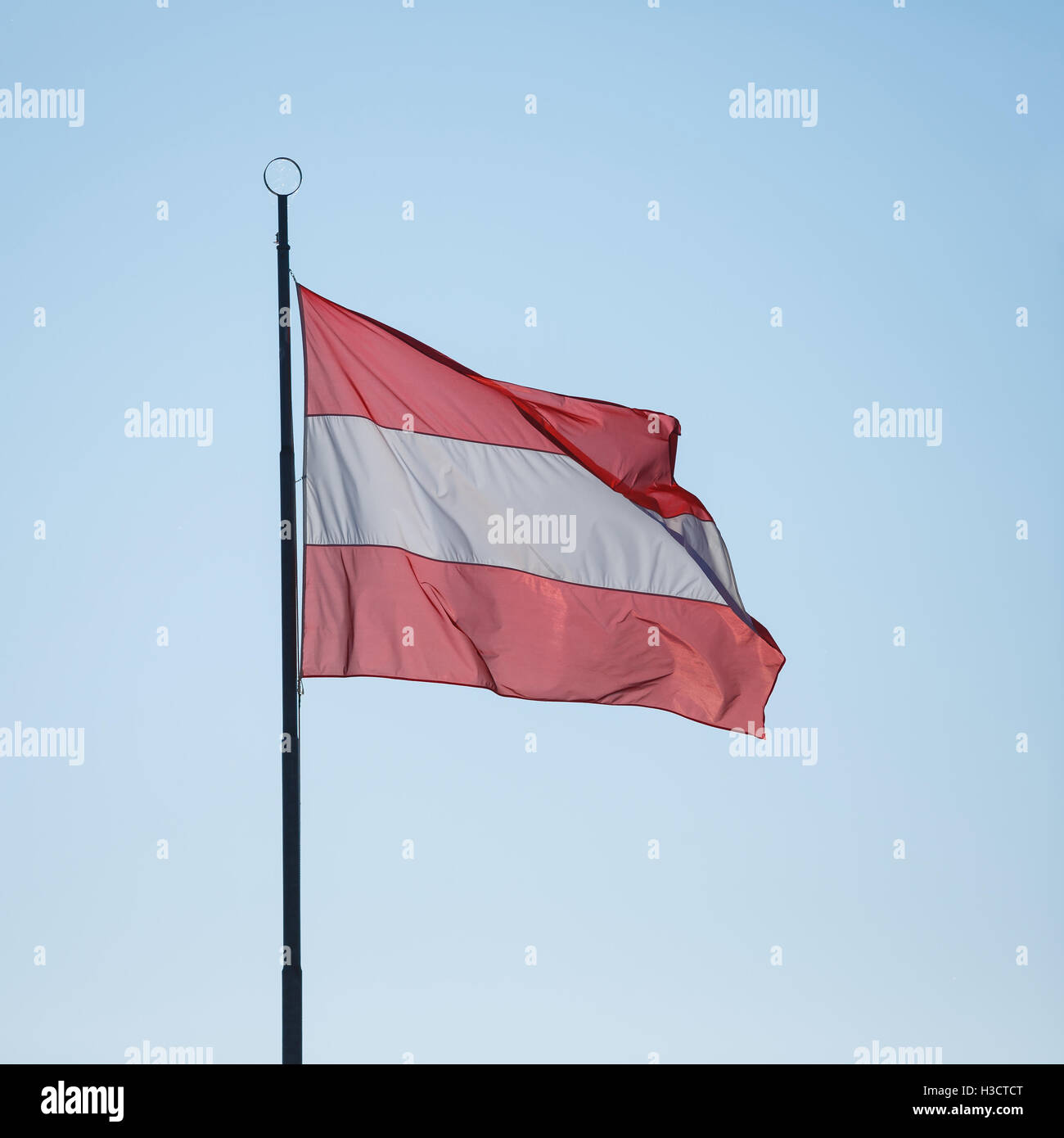 Flag of Austria on the blue sky background Stock Photo