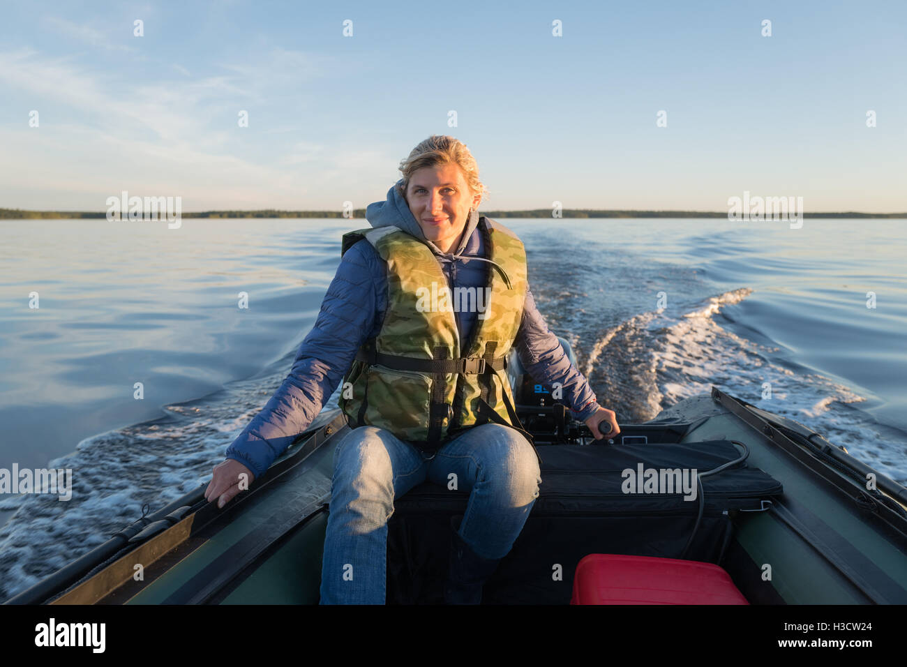 Wonderful woman is operating of boat on the sea Stock Photo