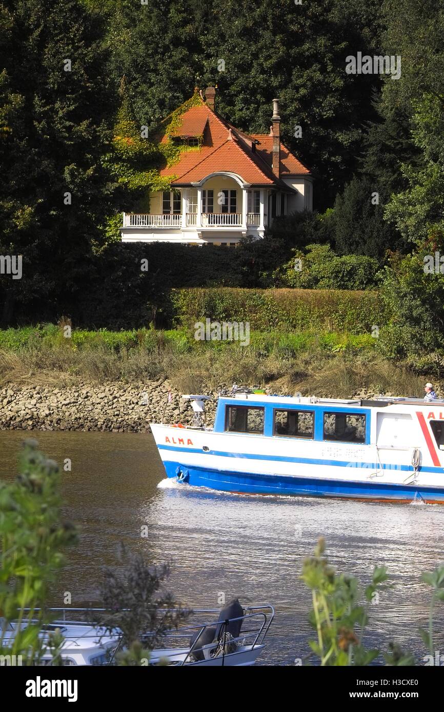 Villa on the riverside of the lake Lesum, crossing riverboat, steamer landscape with a old villa historic architecture Stock Photo
