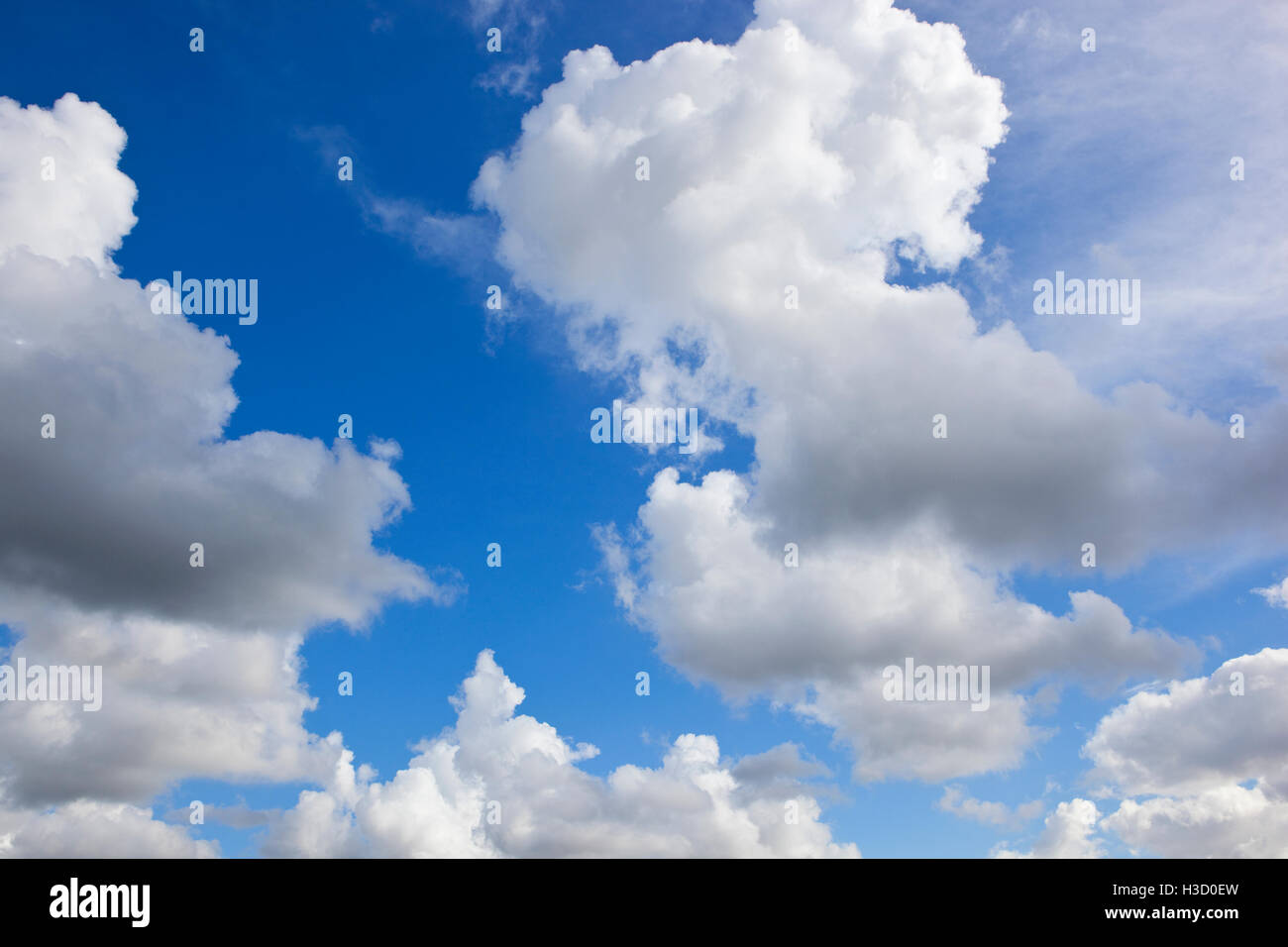 Fluffy gray and white clouds on blue sky background Stock Photo - Alamy