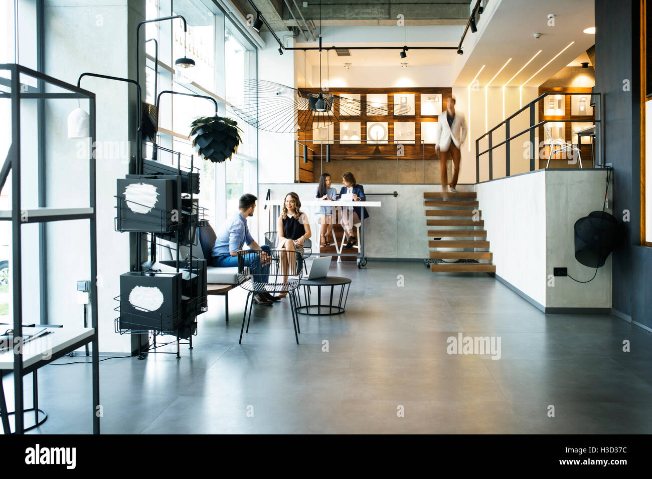 Business people working in brightly lit office Stock Photo