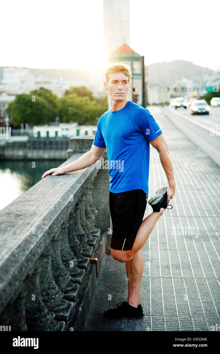 Young sporty man stretching hi-res stock photography and images - Alamy
