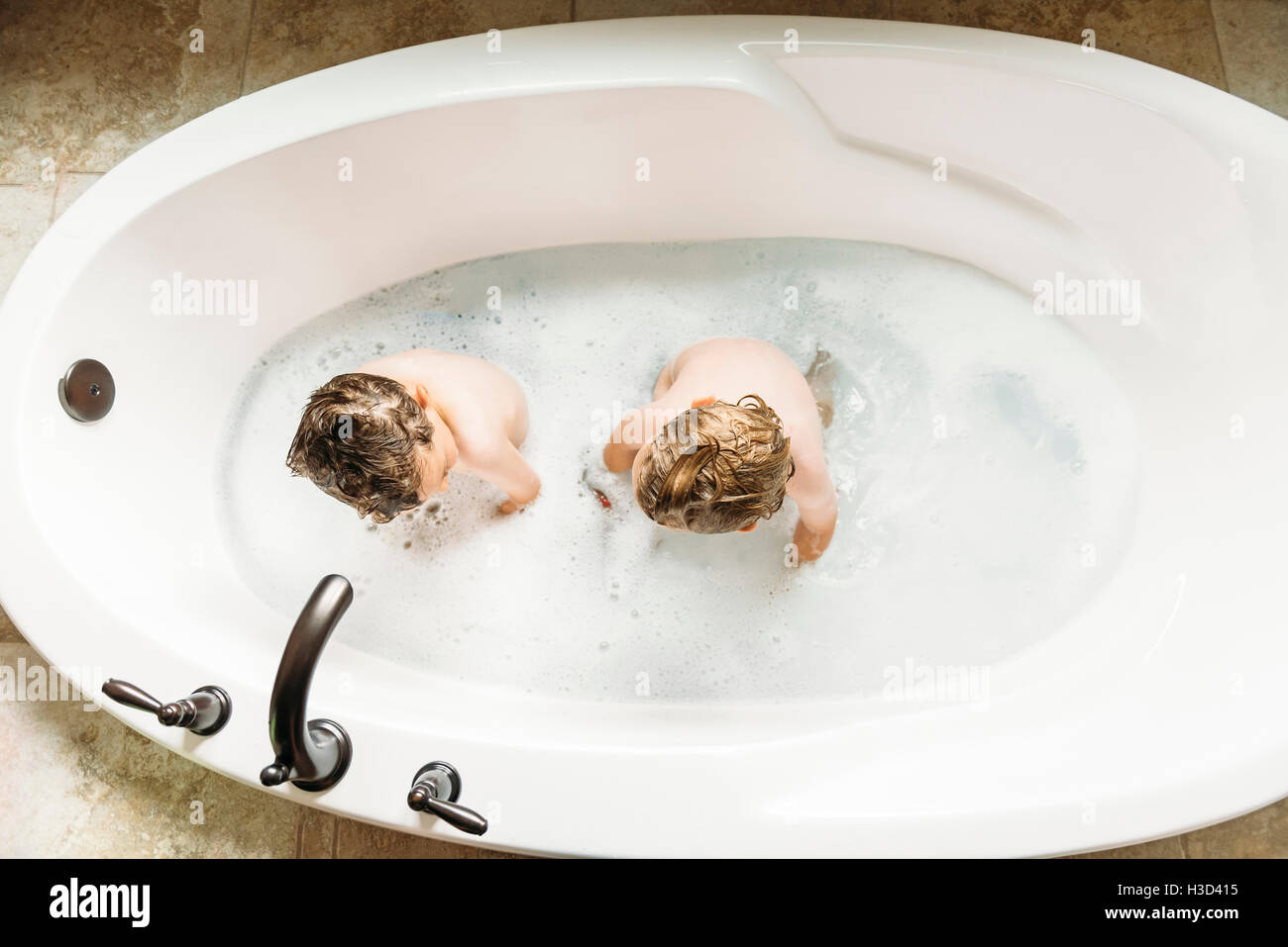 Siblings Bathing Together High Resolution Stock Photography and Images