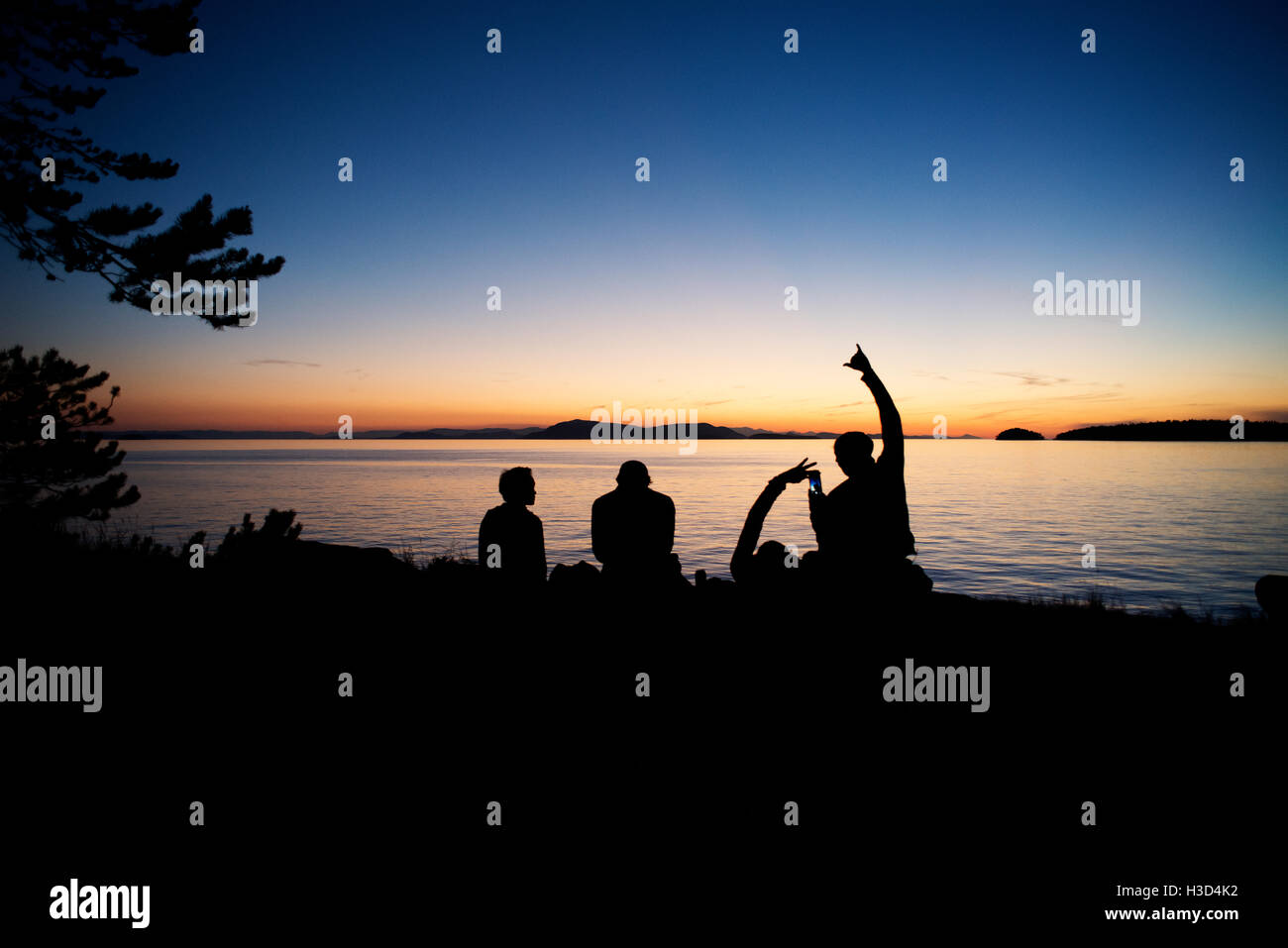 Silhouette men enjoying at Sucia Island against sky during sunset Stock Photo