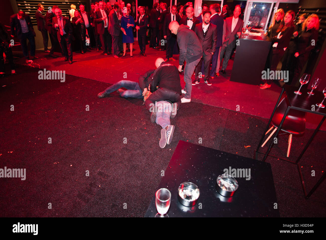 Ghent, Belgium. 06th Oct, 2016. Protesters are thrown to the ground by security as they try to enter a private party in Ghent of the real estate company MG Real Estate because they feel it unrightfully occupies public space. © Frederik Sadones/Pacific Press/Alamy Live News Stock Photo