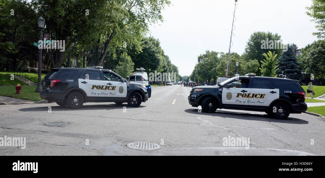 Police cars block entrance to Summit Avenue during a Phil Castle protest at the Governors house. St Paul Minnesota MN USA Stock Photo