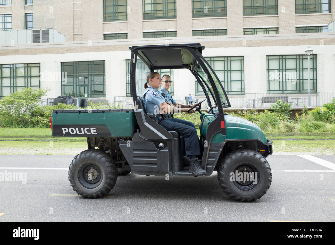 Small off-road Police vehicle patrolling the Midtown Greenway bicycle trail with female police. Minneapolis Minnesota MN USA Stock Photo