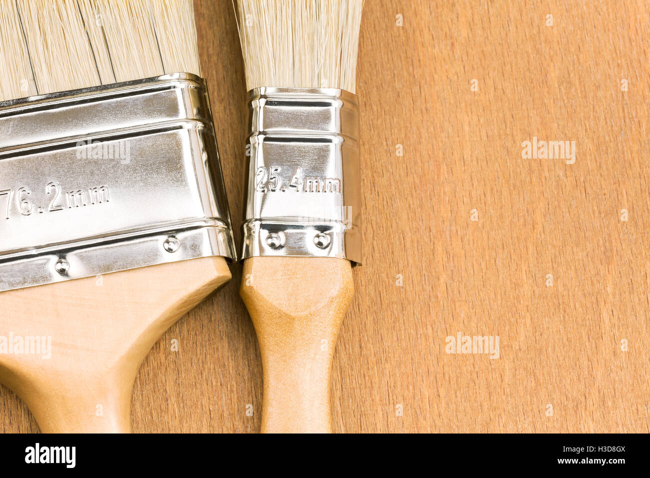 two paint brushes on wooden background with copy space Stock Photo - Alamy