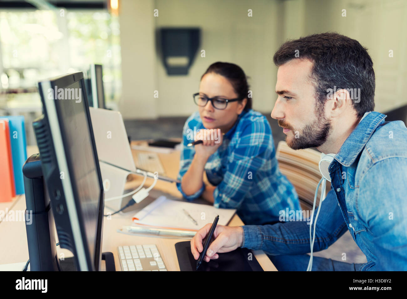 Two freelancers working together in coworking space. Business team meeting in modern office Stock Photo