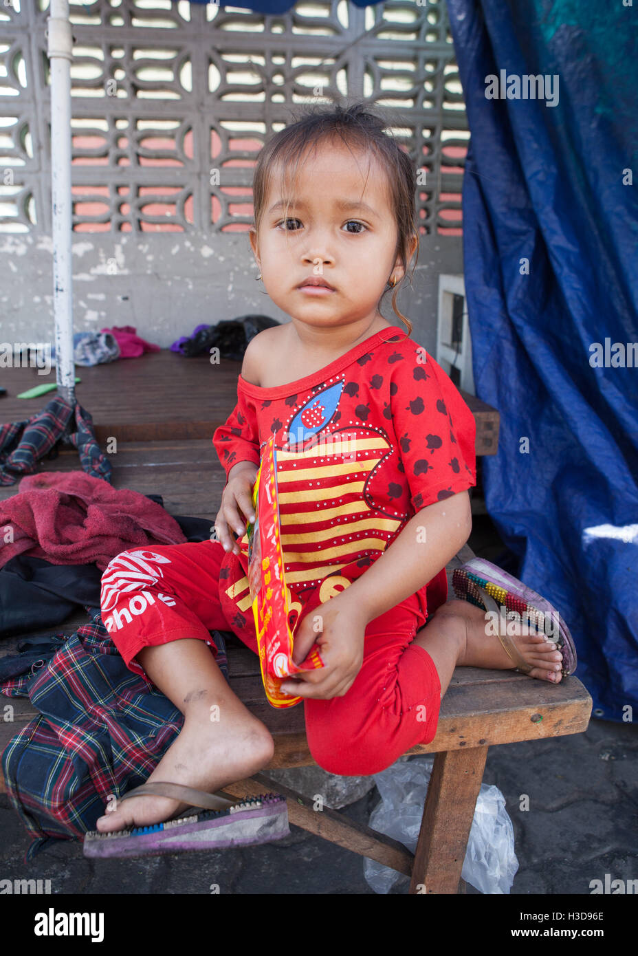 Portrait of the a street vendors child in Phnom Penh. Stock Photo