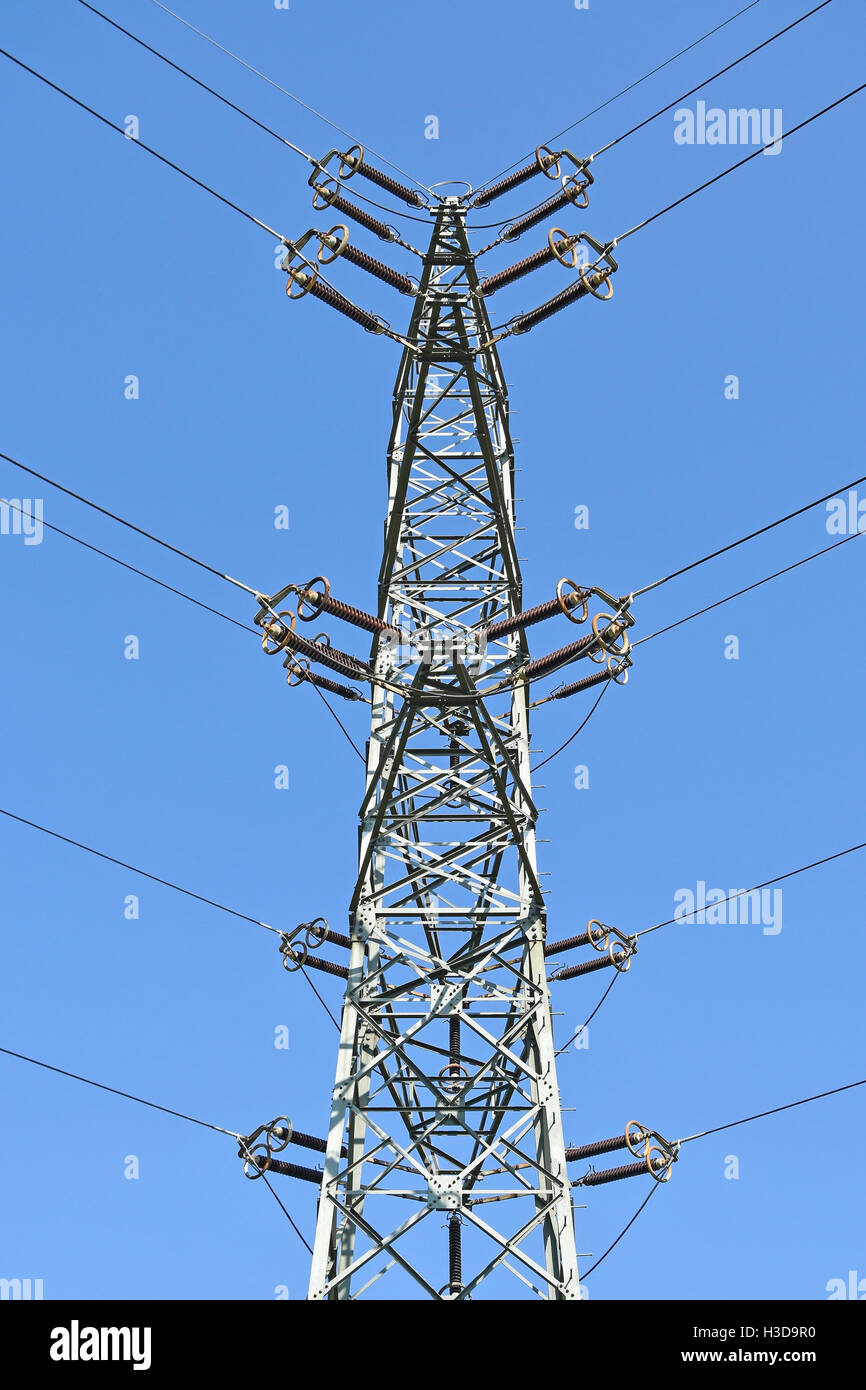 Electricity pylon against blue sky Stock Photo - Alamy