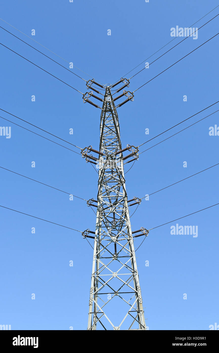 Electricity pylon against blue sky Stock Photo - Alamy