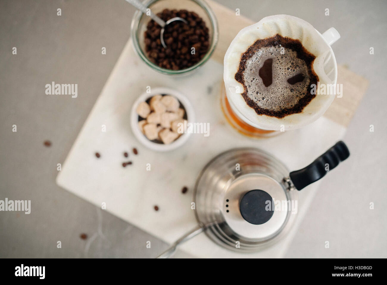 Making filter coffee. Overhead view of ground coffee, paper filter and