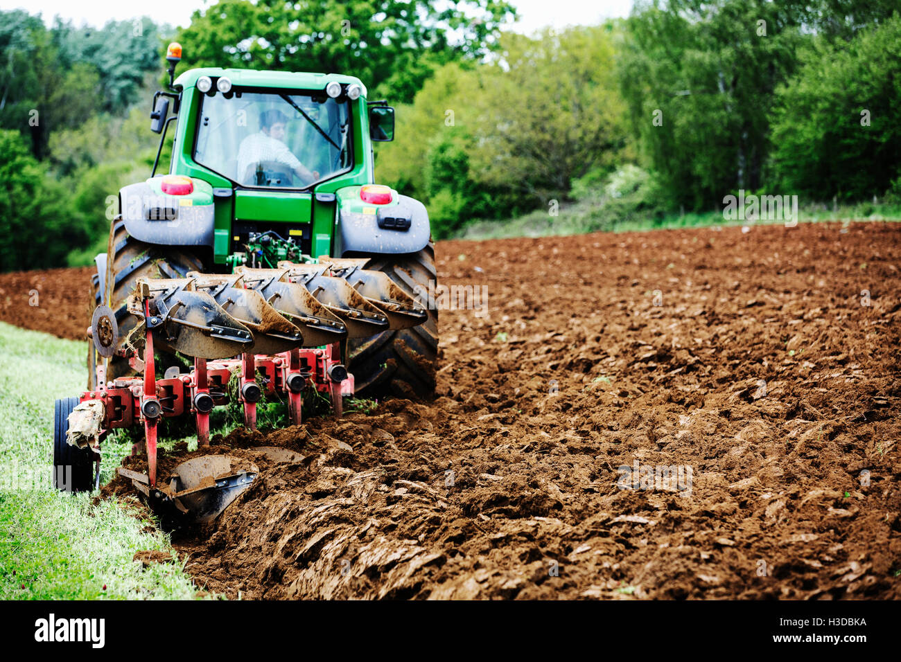 Farmer harrowing his field hires stock photography and images Alamy