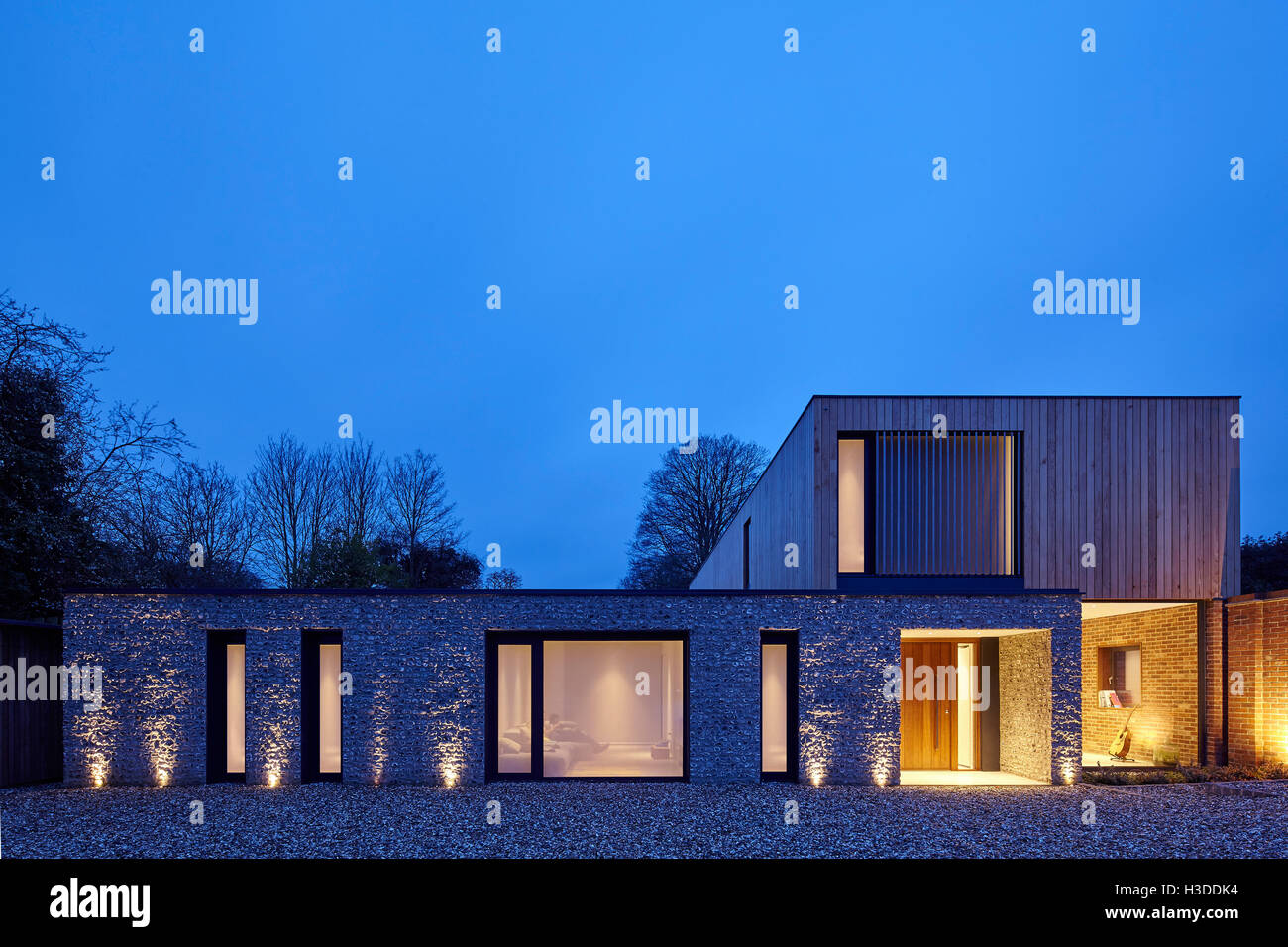 Dusk elevation of house entrance, illuminated. Cheeran House, Lower