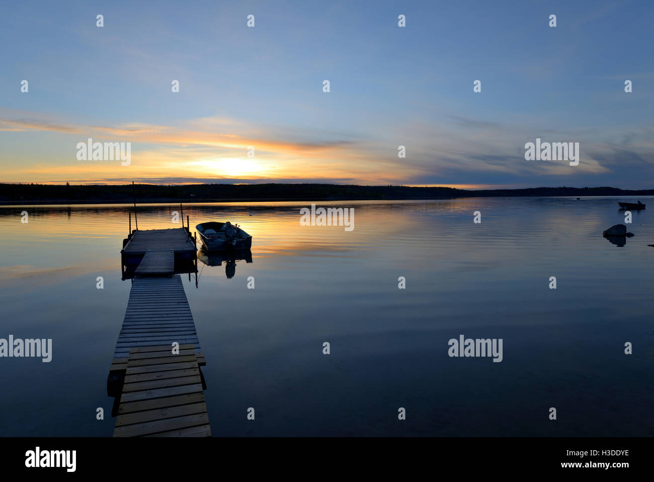 Lake Sunset - Golden sunset at a northern high-latitude lake. Yellowknife, NWT, Canada. Stock Photo