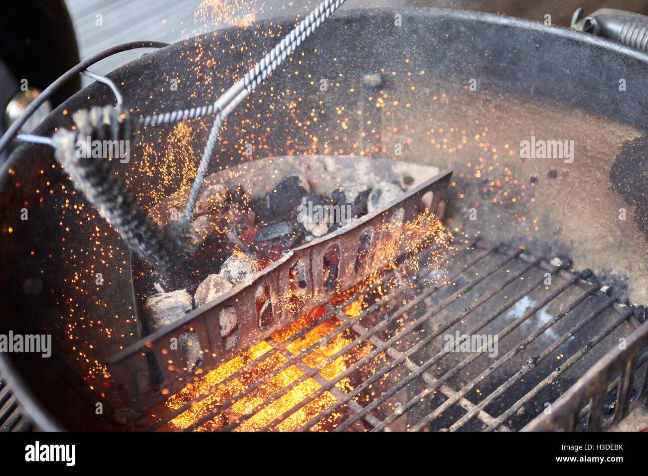 A charcoal barbecue being cleaned Stock Photo Alamy