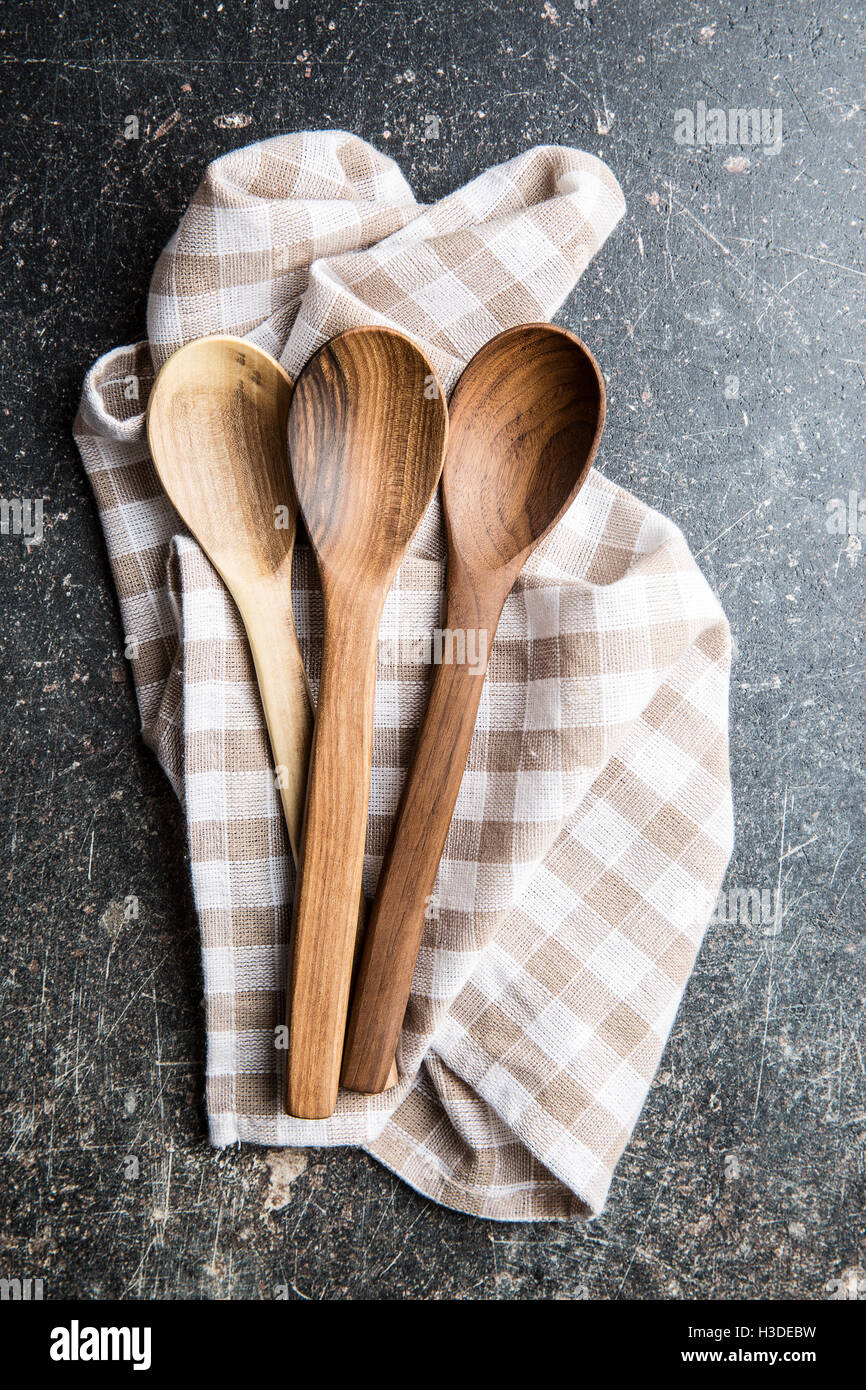 Handmade wooden spoons on checkered napkin. Top view. Stock Photo