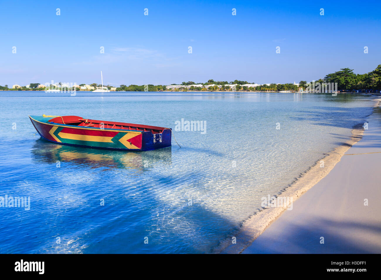 A colorful Jamaican boat floating along the shores of Bloody Bay, Negril. Stock Photo