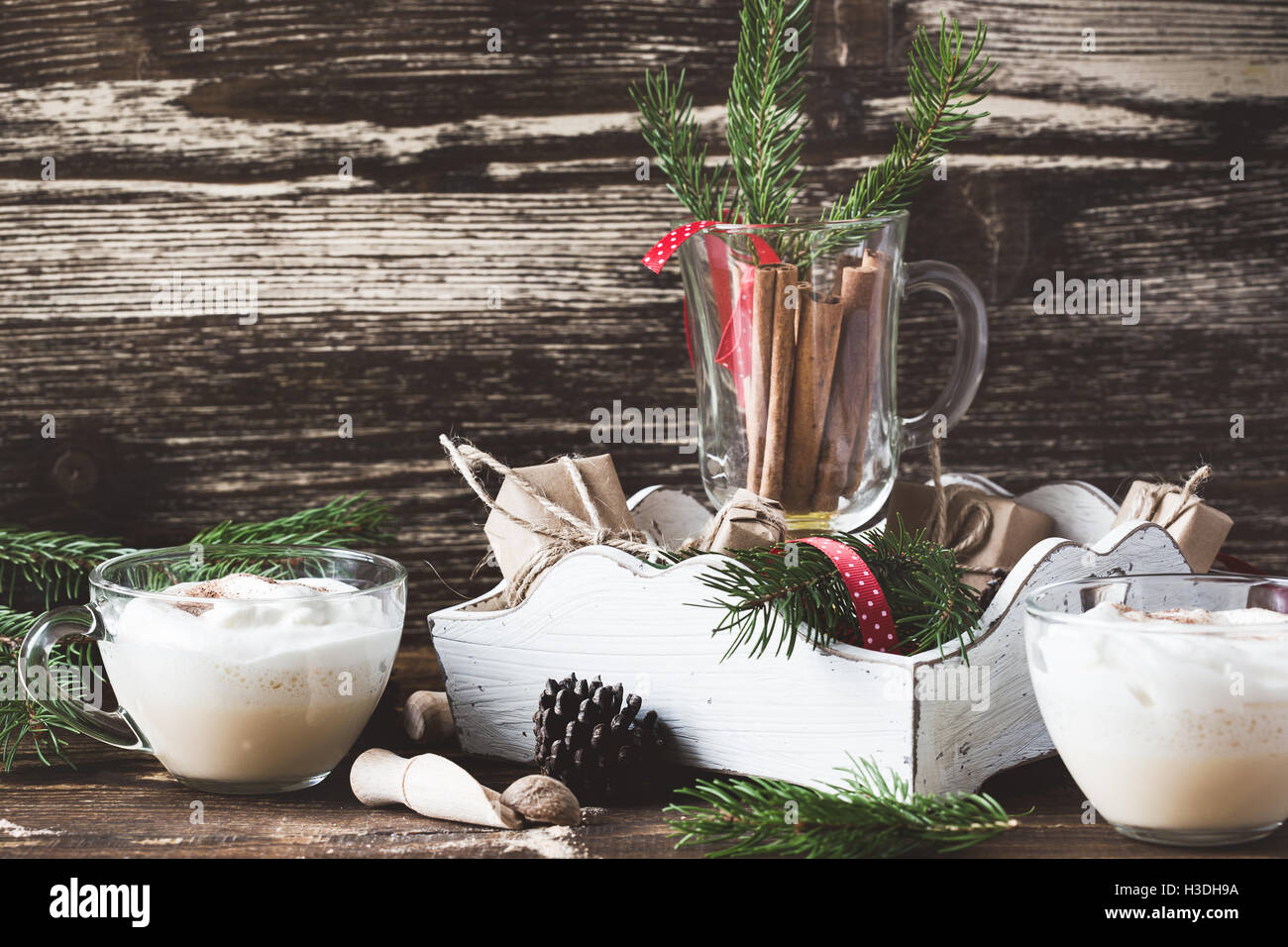 Homemade eggnog with whipped cream in glass on wooden rustic table ...