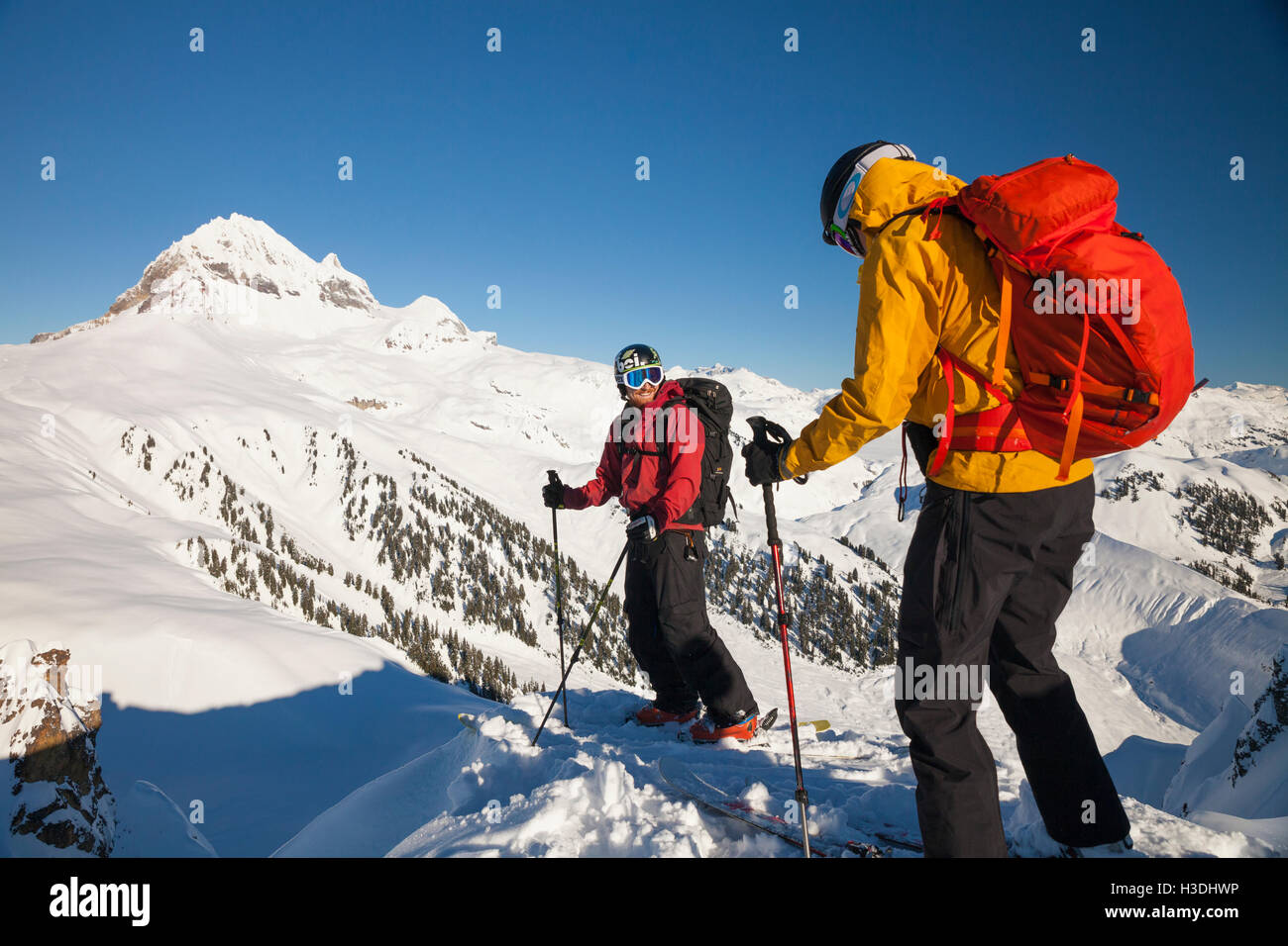 Two skiers on the summit of the Gargoyles near Elfin Lakes in Garibaldi Provincial Park, British Columbia, Canada. Stock Photo