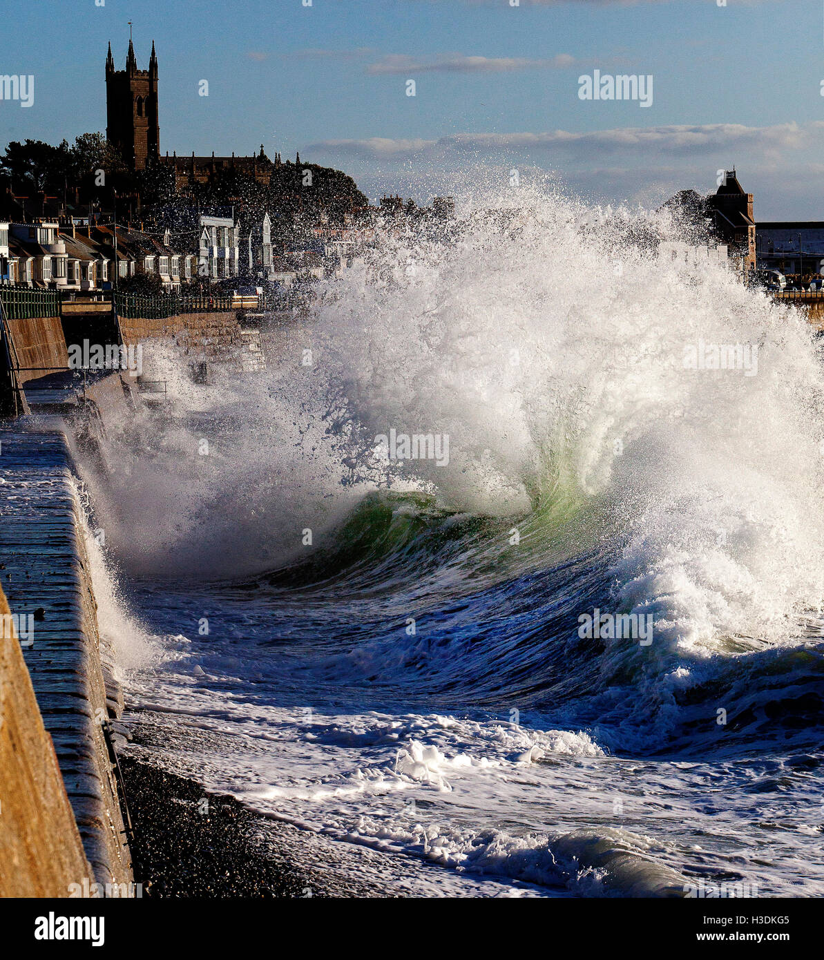 Penzance, Cornwall, UK. 6th October 2016. Large waves from strong winds create huge fans of spray and colour when they are reflected by Penzance Promenade. Pic by Mike Newman/Alamy Live News Stock Photo