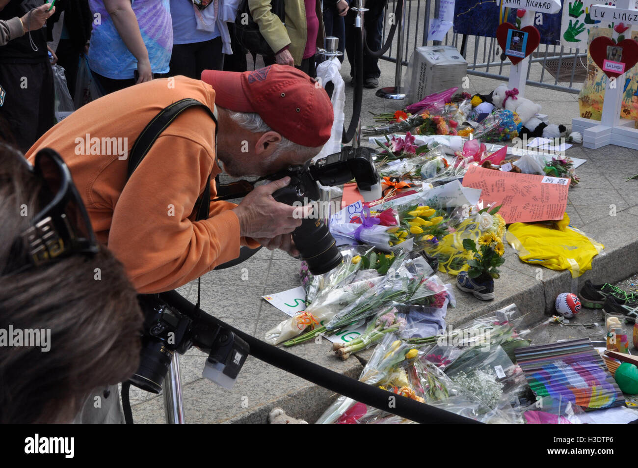 Boston, Massachusetts, USA. 18th Apr, 2013. A photographer shoots items left by people as a memorial to the fallen of the double bombing on Boylston St., during the running of the Boston Marathon on Patriots Day. © Kenneth Martin/ZUMA Wire/Alamy Live News Stock Photo