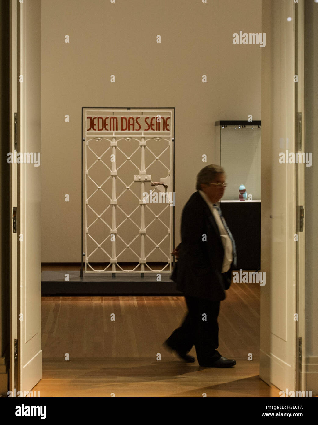 Berlin, Germany. 07th Oct, 2016. Journalists walk past the gate to Buchenwald concentration camp with the lettering 'Jedem das Seine' during the press preview of the exhibition 'Deutschland - Erinnerungen einer Nation' (lit. Germany - Memories of a Nation) at Martin-Gropius-Bau in Berlin, Germany, 07 October 2016. PHOTO: PAUL ZINKEN/DPA/Alamy Live News Stock Photo