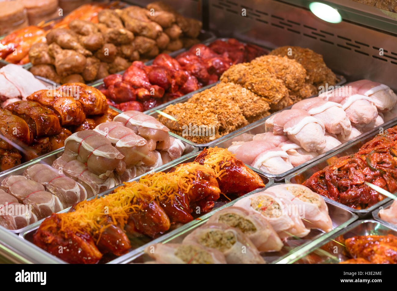 Variety of marinated meat at display counter Stock Photo Alamy