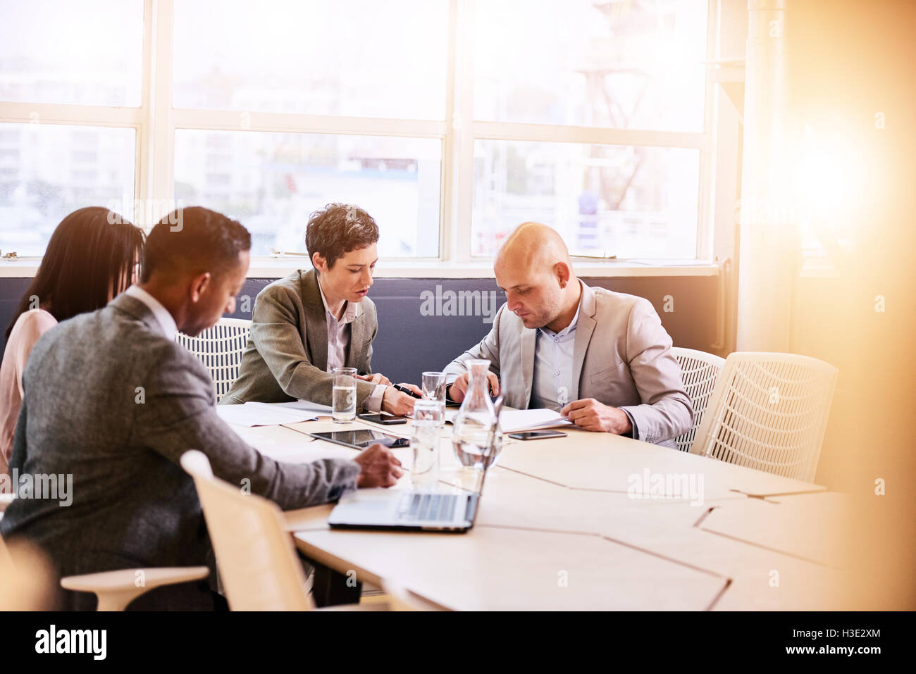 Business meeting between four professional executives in conference room Stock Photo