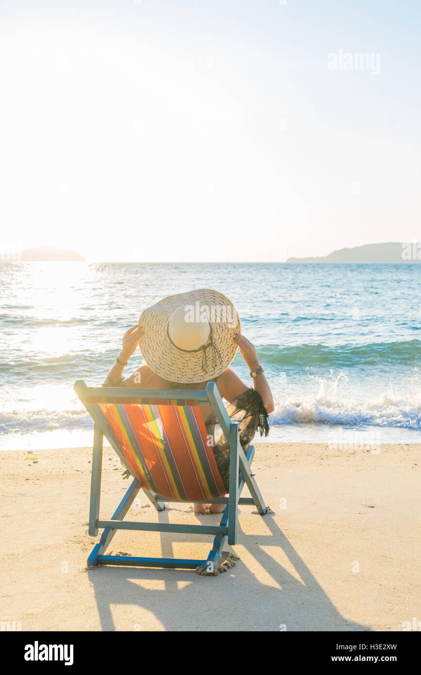 Girl on a tropical beach with a straw hat Stock Photo Alamy