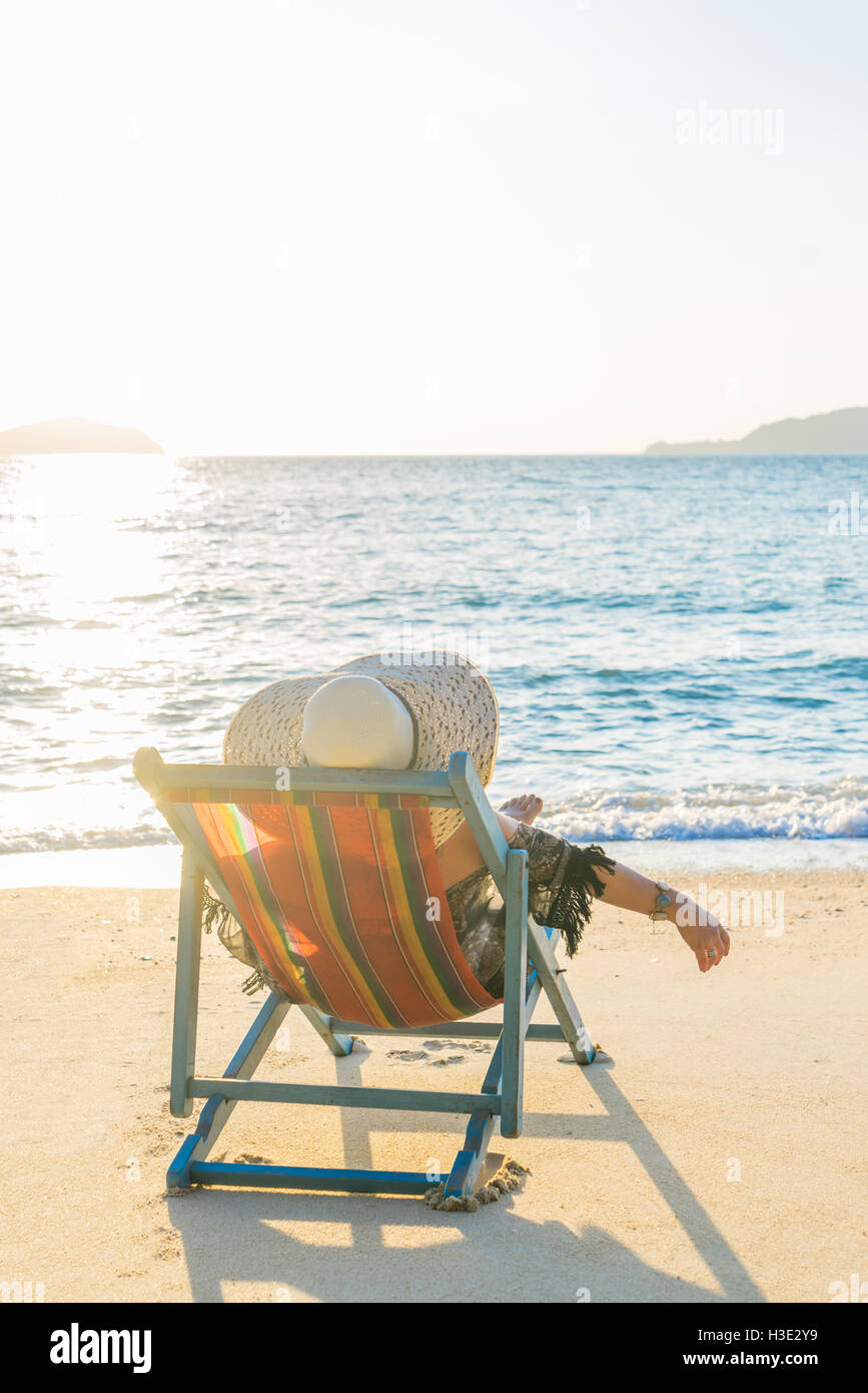 Girl on a tropical beach with a straw hat Stock Photo Alamy